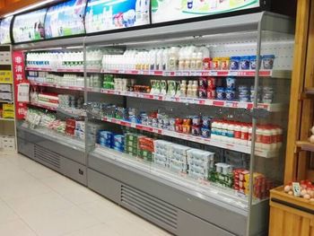 red bull energy drink display open cooler fridge in convenience store